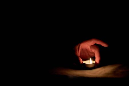 A candle is lit in memory of the victims.の写真素材