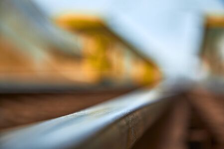 Close up of railway rails railway station in blur. Shallow depth of field.の写真素材