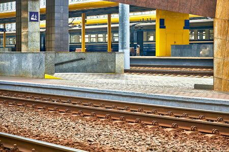 Rails and sleepers. Platform and rails in daylight. Entrance to an underpass on the other sideの写真素材