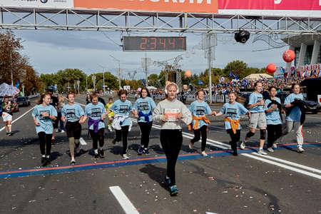 September 15, 2019 Minsk Belarus Minsk hosts a half-marathon where happy girls in identical costumes cross the finish lineのeditorial素材