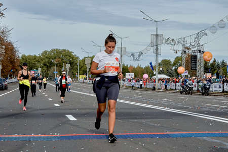 September 15, 2019 Minsk Belarus There a young woman crosses the finish line of a marathonのeditorial素材