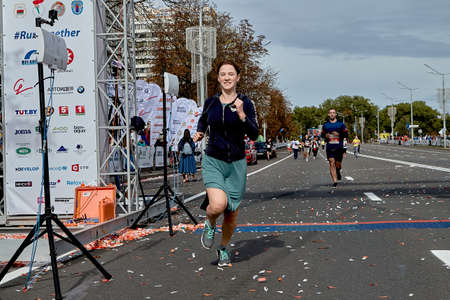 September 15, 2019 Minsk Belarus A marathon race in which an active happy young woman in a skirt crosses the finish lineのeditorial素材