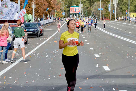 September 15, 2019 Minsk Belarus A marathon race in which a beautiful woman runs ahead of the participants of the half marathon in Minsk.のeditorial素材