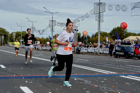 September 15, 2019 Minsk Belarus Minsk hosts a half marathon where an active woman crosses the finish lineのeditorial素材