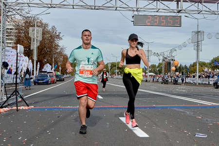 September 15, 2019 Minsk Belarus Minsk hosts a half-marathon where a couple crosses the finish lineのeditorial素材