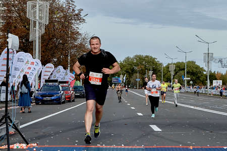 September 15, 2019 Minsk Belarus Minsk hosts a half-marathon where a happy athlete runs to the finish lineのeditorial素材