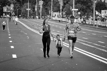 September 15, 2019 Minsk Belarus In the black-and-white image, Minsk hosts a half marathon where a happy family runs along a city roadのeditorial素材