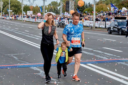 September 15, 2019 Minsk Belarus Minsk hosts a half marathon where a happy family runs across the finish lineのeditorial素材