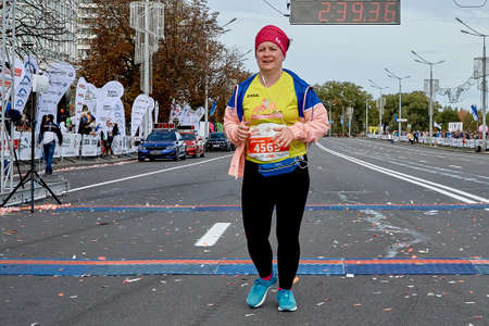 September 15, 2019 Minsk Belarus A half-marathon is taking place in Minsk, where a happy plump woman crosses the finish line on a city roadのeditorial素材