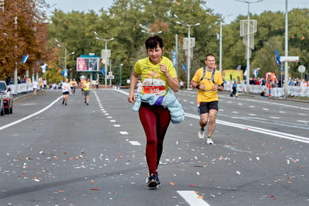 September 15, 2019 Minsk Belarus A marathon race in which an active woman runs to the finish lineのeditorial素材