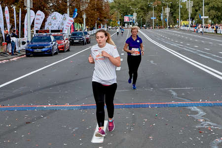 September 15, 2019 Minsk Belarus A marathon race in which an active woman crosses the finish line on a city roadのeditorial素材