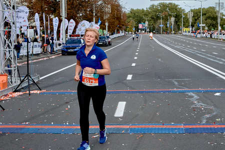 September 15, 2019 Minsk Belarus Minsk hosts a half-marathon, where an elderly active woman crosses the finish lineのeditorial素材
