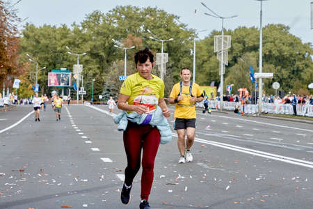September 15, 2019 Minsk Belarus A marathon race in which a close-up of an active woman runs to the finish lineのeditorial素材