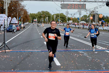 September 15, 2019 Minsk Belarus A marathon race in which a happy man and two women cross the finish lineのeditorial素材