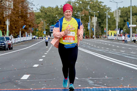 September 15, 2019 Minsk Belarus Minsk hosts a half-marathon where a plump woman runs along a city roadのeditorial素材
