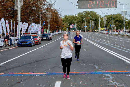 September 15, 2019 Minsk Belarus A marathon race in which an active woman crosses the finish line on a city roadのeditorial素材