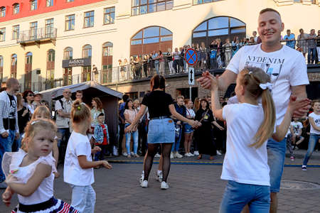 June 1, 2019 Minsk Belarus Father and happy daughter dancing at a street concertのeditorial素材