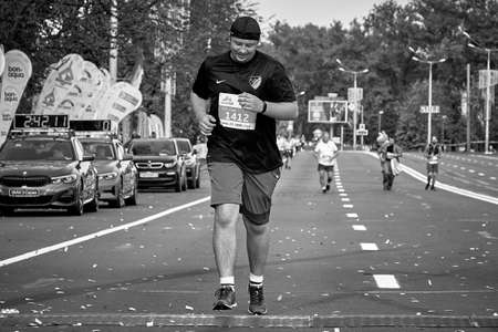 September 15, 2019 Minsk Belarus In black and white-a marathon race in which a happy athlete runs to the finish lineのeditorial素材