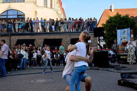 June 1, 2019 Minsk Belarus A street concert where a father and a little girl dance in front of a crowd of peopleのeditorial素材