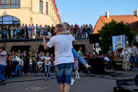 June 1, 2019 Minsk Belarus A street concert where a happy father and little daughter dance in front of a crowd of peopleのeditorial素材