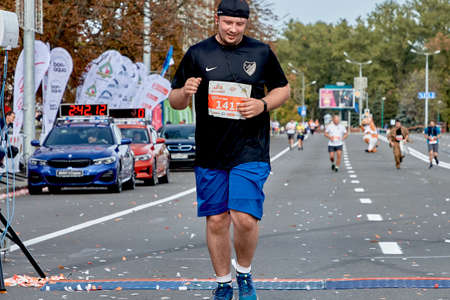 September 15, 2019 Minsk Belarus Minsk hosts a half-marathon where a close-up of a happy participant crosses the finish lineのeditorial素材