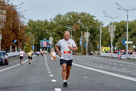 September 15, 2019 Minsk Belarus A marathon race in which a Mature athlete runs to the finish lineのeditorial素材