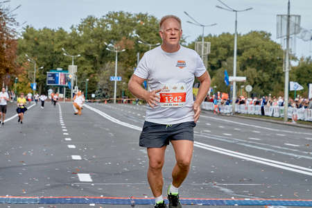 September 15, 2019 Minsk Belarus A marathon race in which an elderly participant crosses the finish line in close-upのeditorial素材