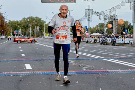 September 15, 2019 Minsk Belarus Minsk hosts a half-marathon where an elderly athlete crosses the finish lineのeditorial素材