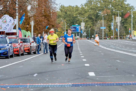 September 15, 2019 Minsk Belarus A half-marathon is being held in Minsk, where two elderly women run along a city roadのeditorial素材
