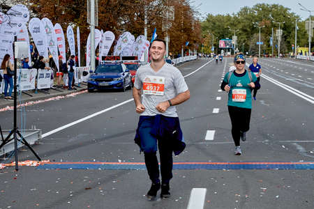 September 15, 2019 Minsk Belarus A happy athlete crosses the finish line of the marathon ahead of the participantsのeditorial素材