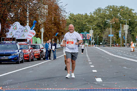 September 15, 2019 Minsk Belarus A happy sportsman runs along a city roadのeditorial素材