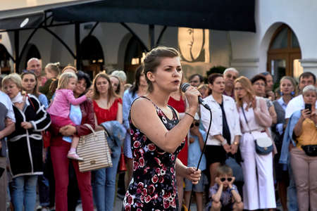 May 25, 2019 Minsk Belarus A young woman with a microphone sings in front of a crowd of peopleのeditorial素材