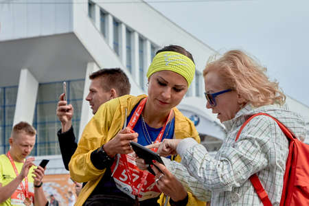 September 15, 2019 Minsk Belarus Participants look at their smartphones after the marathonのeditorial素材