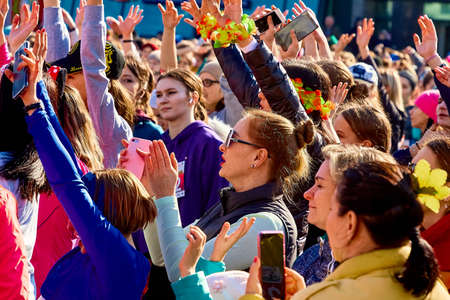 March 8, 2019 Minsk Belarus Women's Day Race on March 8 Beautiful happy women with raised hands stand at a street concertのeditorial素材