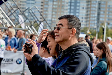 September 15, 2019 Minsk Belarus Happy spectators take photos on their phones during the marathonのeditorial素材