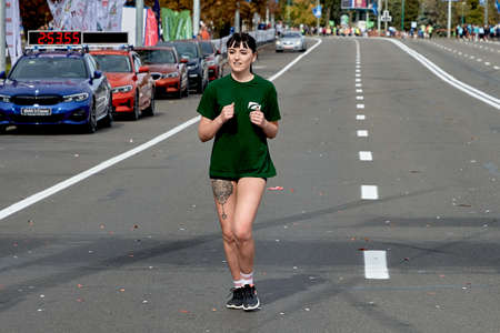 September 15, 2019 Minsk Belarus A marathon race in which a beautiful young woman runs along a city roadのeditorial素材