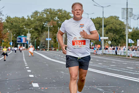 September 15, 2019 Minsk Belarus A marathon race in which an elderly participant runs to the finish line in close-upのeditorial素材