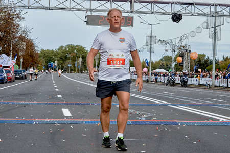 September 15, 2019 Minsk Belarus A marathon race in which a Mature participant crossed the finish line in close-upのeditorial素材