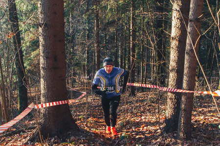November 17, 2018 Logoisk Belarus Beetle-trail 8 LOGOISK An adult athlete runs through the woods. An athlete in a tracksuit with a chest number.のeditorial素材