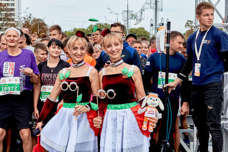 September 15, 2019 Minsk Belarus There are two women twins in carnival glasses stand before the start of the marathonのeditorial素材