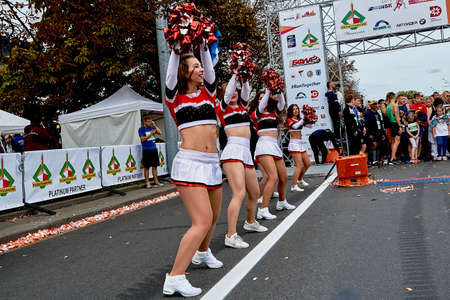 September 15, 2019 Minsk Belarus There are happy beautiful girls dancing next to athletes before the start of the half marathonのeditorial素材