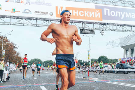 September 9, 2018 Minsk Belarus Half Marathon Minsk 2018 A marathon race in which a bare-chested marathon runner crosses the finish line ahead of the participantsのeditorial素材