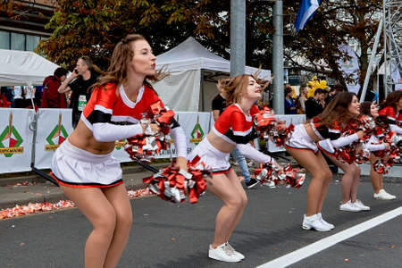September 15, 2019 Minsk Belarus At the start of the marathon support group dancers perform beautifully with large bows in their handsのeditorial素材