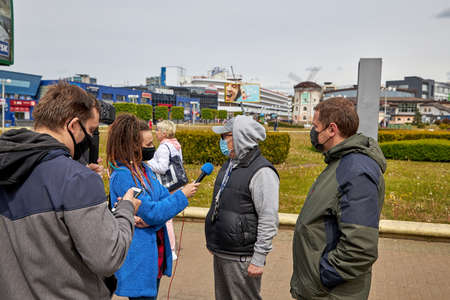 May 24 2020 Minsk Belarus Collecting votes for opposition candidates to participate in elections on the street where the press with a camera and microphone asking people questionsのeditorial素材