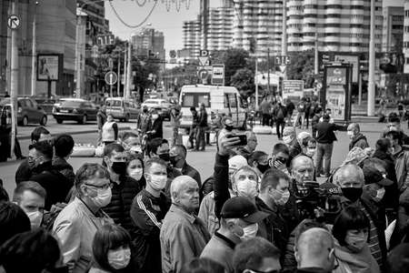 May 24 2020 Minsk Belarus In the black-and-white image, masked people stand close to each other to protest during the pandemic in the squareのeditorial素材