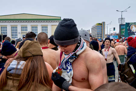 February 23, 2019 Minsk Belarus The race in honor of the holiday on February 23 A strong man with a bare torso holds a medal in his handのeditorial素材