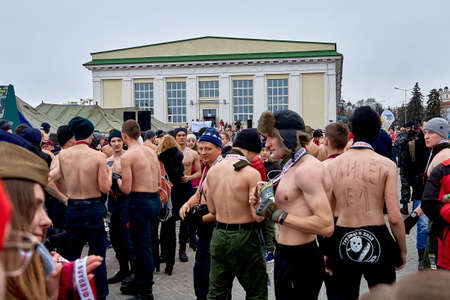 February 23, 2019 Minsk Belarus The race in honor of the holiday on February 23 A men with a naked torso in a nordic hats and man with a camera stand after the raceのeditorial素材