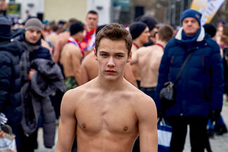 February 23, 2019 Minsk Belarus The race in honor of the holiday on February 23 A strong young man standing with a naked torso in the open air in winterのeditorial素材