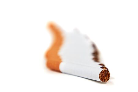 Cigarettes lies with a filter to us on a white backgroundの写真素材