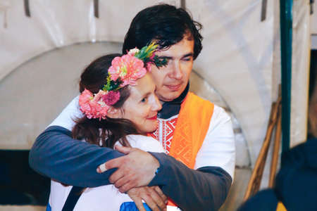 July 6-7, 2019 Village Petrevichi Minsk region Belarus Beetle trail 12 A loving man embraces his wife with a wreath of flowers on her headのeditorial素材